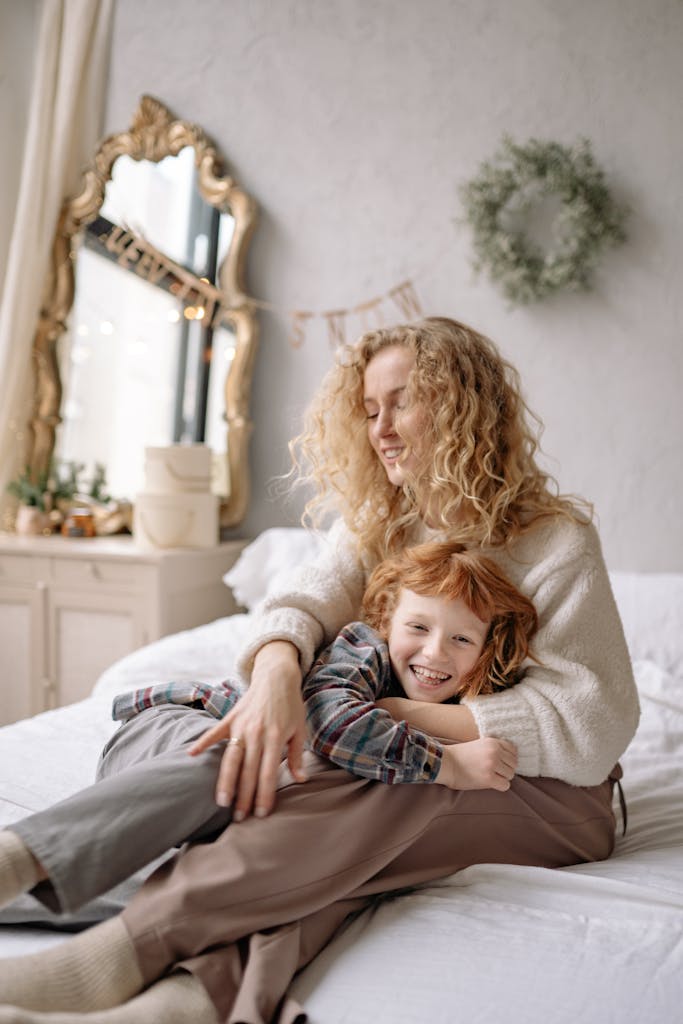 Loving moment between mother and son in a cozy bedroom, emphasizing family bonding and warmth.